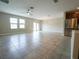 Open living area with ceramic tile, stainless steel refrigerator, and slider to the backyard at 9650 Sage Creek Dr, Ruskin, FL 33573