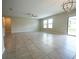 Open living room features ceramic tile, windows, and modern ceiling fan at 9650 Sage Creek Dr, Ruskin, FL 33573
