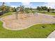 Community playground with a swing set, climbing structure, and benches at 9650 Sage Creek Dr, Ruskin, FL 33573