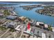 Stunning aerial view of waterfront property with boat access, pool, and beautiful bay waters at 10280 Gulf Blvd # 12, St Petersburg, FL 33706