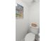 Powder room with modern toilet and framed photo at 10280 Gulf Blvd # 12, St Petersburg, FL 33706