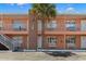 Attractive two-story building showcasing clean lines, exterior benches and inviting balconies at 10280 Gulf Blvd # 12, St Petersburg, FL 33706