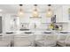 Bright kitchen featuring modern appliances, pendant lighting, and sleek countertops with barstool seating at 10280 Gulf Blvd # 12, St Petersburg, FL 33706