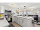 Open kitchen with white cabinets, quartz countertops, and view to living area at 10280 Gulf Blvd # 12, St Petersburg, FL 33706