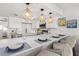 Kitchen bar with white quartz countertops and pendant lights with adjacent bar stool seating at 10280 Gulf Blvd # 12, St Petersburg, FL 33706
