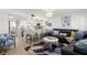 Stylishly furnished living room with modern kitchen featuring counter seating, stainless steel appliances at 10280 Gulf Blvd # 12, St Petersburg, FL 33706