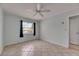 Bedroom features neutral colors, ceiling fan, and window views at 1049 Apollo Beach Blvd # D, Apollo Beach, FL 33572
