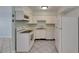Bright kitchen features white appliances, cabinets, and diagonal tile flooring at 1049 Apollo Beach Blvd # D, Apollo Beach, FL 33572