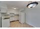 White kitchen with a large refrigerator and adjacent dining area with decorative lighting at 1049 Apollo Beach Blvd # D, Apollo Beach, FL 33572