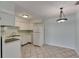 Compact kitchen features white appliances, ample cabinet space, and tile flooring at 1049 Apollo Beach Blvd # D, Apollo Beach, FL 33572