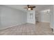 Living area with tile floors, a ceiling fan, and a mirror accent at 1049 Apollo Beach Blvd # D, Apollo Beach, FL 33572