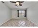 Living room featuring tile floors, ceiling fan, and a window with views of the exterior at 1049 Apollo Beach Blvd # D, Apollo Beach, FL 33572