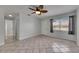 Living area with tile floors, ceiling fan, and a large window, offering a bright and airy space at 1049 Apollo Beach Blvd # D, Apollo Beach, FL 33572