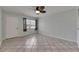Inviting living room with tile flooring, a ceiling fan, and natural light from the window at 1049 Apollo Beach Blvd # D, Apollo Beach, FL 33572