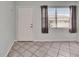 Bright room featuring tile flooring, neutral walls, a large window, and an entry door at 1049 Apollo Beach Blvd # D, Apollo Beach, FL 33572