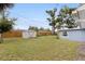Backyard with green grass, storage shed, and a wood fence at 11451 82Nd Ave, Seminole, FL 33772