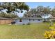 View of the backyard, displaying the home's exterior, lush lawn, and patio area at 11451 82Nd Ave, Seminole, FL 33772