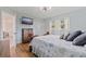 Bedroom featuring wood-look flooring, a TV and updated lighting at 11451 82Nd Ave, Seminole, FL 33772