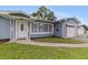 Inviting home exterior showcasing a well-kept lawn, quaint front door, and a one-car garage at 11451 82Nd Ave, Seminole, FL 33772