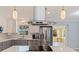 Contemporary kitchen featuring stainless steel appliances, stylish range hood, and an open layout at 11451 82Nd Ave, Seminole, FL 33772