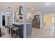 Modern kitchen with white cabinets, stainless steel appliances, and a center island with bar seating at 11451 82Nd Ave, Seminole, FL 33772