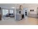 Open living space with kitchen island, stainless steel range hood, comfortable sofa, and wood flooring at 11451 82Nd Ave, Seminole, FL 33772