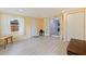 Light-filled room with neutral walls, wood floors, white trim, and multiple entryways at 11451 82Nd Ave, Seminole, FL 33772