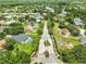 Wide aerial view of homes in the area; tropical landscaping and community pond at 12305 Freesia Ct, Riverview, FL 33569