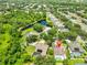 Aerial view of the home with screened-in pool and solar panels in a lush neighborhood at 12305 Freesia Ct, Riverview, FL 33569