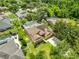 Aerial view of home showing screen enclosed pool, well-manicured lawn and fenced yard at 12305 Freesia Ct, Riverview, FL 33569