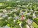 Aerial view of the home with a screened-in pool in a lush, green neighborhood at 12305 Freesia Ct, Riverview, FL 33569