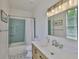 Nicely appointed bathroom featuring attractive tile floors, tile shower, and a wood vanity with quartz countertop at 12305 Freesia Ct, Riverview, FL 33569