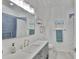 Beautiful bathroom featuring blue accent tiles, white vanity with quartz countertop, a sink, and chrome fixtures at 12305 Freesia Ct, Riverview, FL 33569
