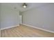 Bright bedroom featuring wood floors, modern ceiling fan, and neutral wall paint at 12305 Freesia Ct, Riverview, FL 33569