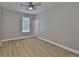 Clean bedroom with wood floors, lots of natural light, and a neutral color palette at 12305 Freesia Ct, Riverview, FL 33569