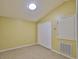 Bedroom with bright yellow walls, beige floors, closet, and circular ceiling light at 12305 Freesia Ct, Riverview, FL 33569