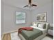 Cozy bedroom featuring a ceiling fan, hardwood floors, natural light, and modern furnishings at 12305 Freesia Ct, Riverview, FL 33569