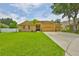 Charming home boasts lush lawn, mature trees, and a spacious three car garage at 12305 Freesia Ct, Riverview, FL 33569