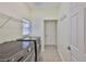 Laundry room with modern washer and dryer, wire shelf, and tiled floors at 12305 Freesia Ct, Riverview, FL 33569