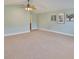 Spacious living room with light-colored walls, carpet flooring, and decor at 12305 Freesia Ct, Riverview, FL 33569