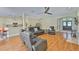 Open-concept living room featuring wood floors, modern furniture, and natural light at 12305 Freesia Ct, Riverview, FL 33569