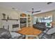 Cozy living room has a stone fireplace and sliding doors to the outdoor pool at 12305 Freesia Ct, Riverview, FL 33569