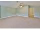 Large living area with plush carpeting, light-colored walls, and a ceiling fan at 12305 Freesia Ct, Riverview, FL 33569