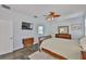 Bright main bedroom featuring wood floors, modern furniture, and en-suite bathroom access at 12305 Freesia Ct, Riverview, FL 33569
