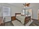 Well-lit main bedroom with a ceiling fan and large windows at 12305 Freesia Ct, Riverview, FL 33569