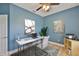 Cozy office space with modern decor, including a marble desk, stylish art, a ceiling fan, and blue walls at 12305 Freesia Ct, Riverview, FL 33569
