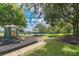 Neighborhood playground featuring play structures and grassy areas adjacent to a walking path at 12305 Freesia Ct, Riverview, FL 33569