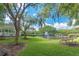 Scenic pond view with a fountain and a gazebo, surrounded by green grass and trees at 12305 Freesia Ct, Riverview, FL 33569