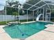 Screened-in pool with slide, waterfall feature, and well-maintained landscaping at 12305 Freesia Ct, Riverview, FL 33569