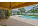 Screened-in pool with spacious patio, ceiling fan, and lush landscaping at 12305 Freesia Ct, Riverview, FL 33569